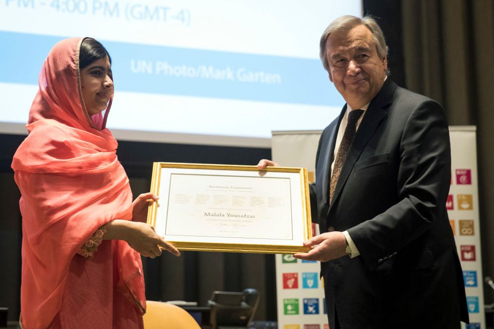 Malala Yousafzai is presented a certificate from UN Secretary-General Antonio Guterres