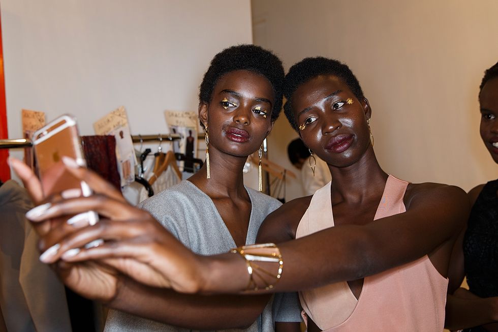 Models taking selfie backstage