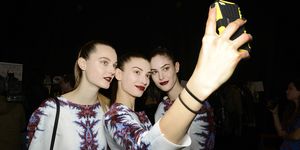 Models taking a selfie at fashion week