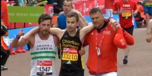 Matthew Rees helps athlete across the finish line of the London Marathon