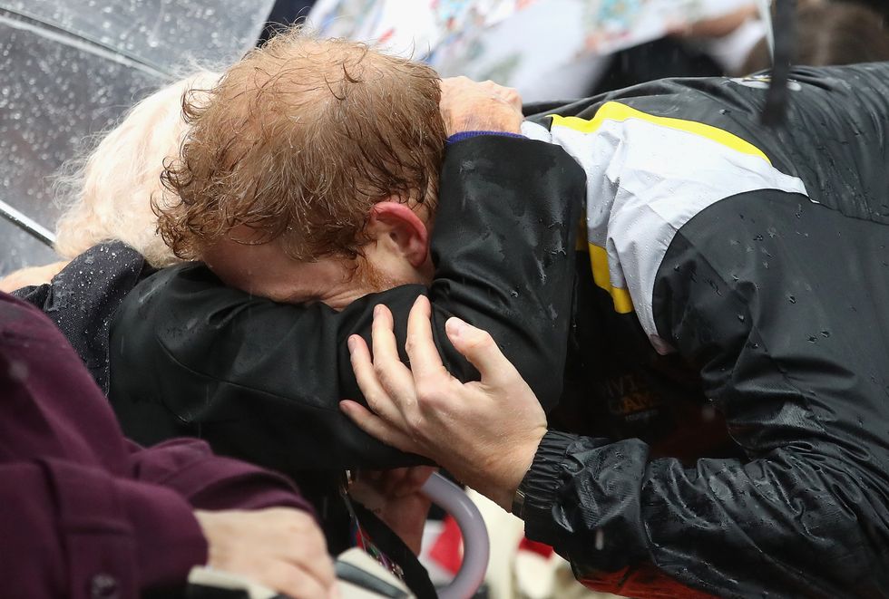 Prince Harry, hugs and kisses royal fan Daphne Dunne in Sydney as he promotes the Invictus Games in Sydney