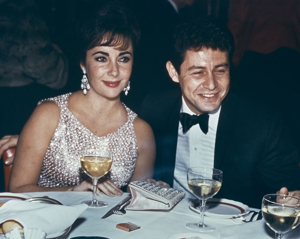<p>Renowned for her impressive jewelry collection, La Liz wore a crystal beaded dress and statement earrings for a dinner with then-husband Eddie Fisher in 1959.</p>