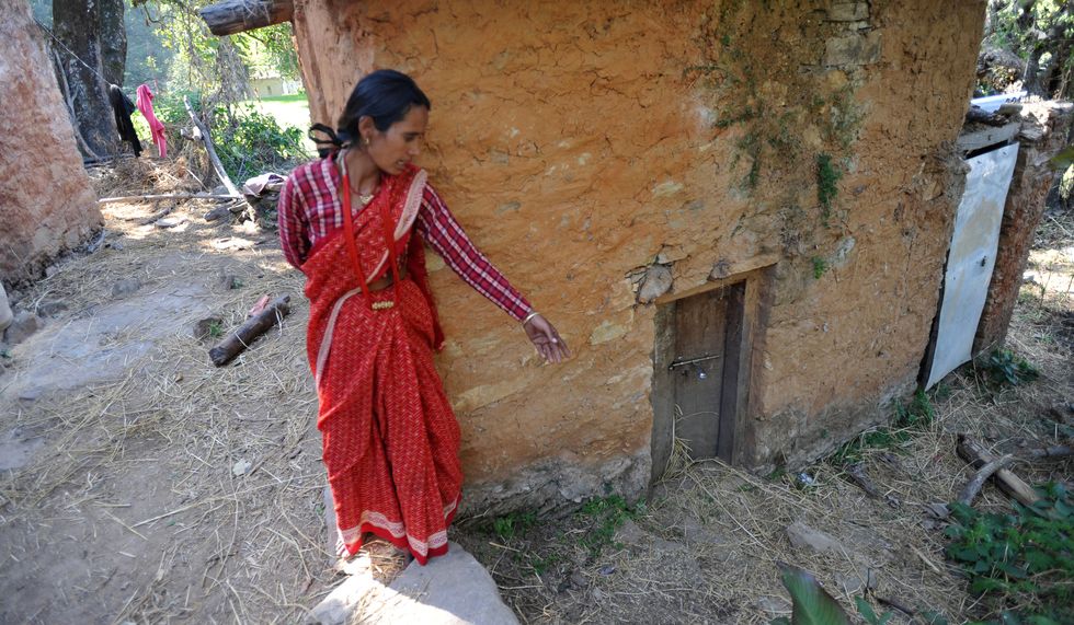 A Nepalese woman shows her chaupadi house