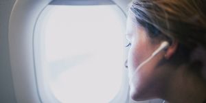 woman on aeroplane looking out of window