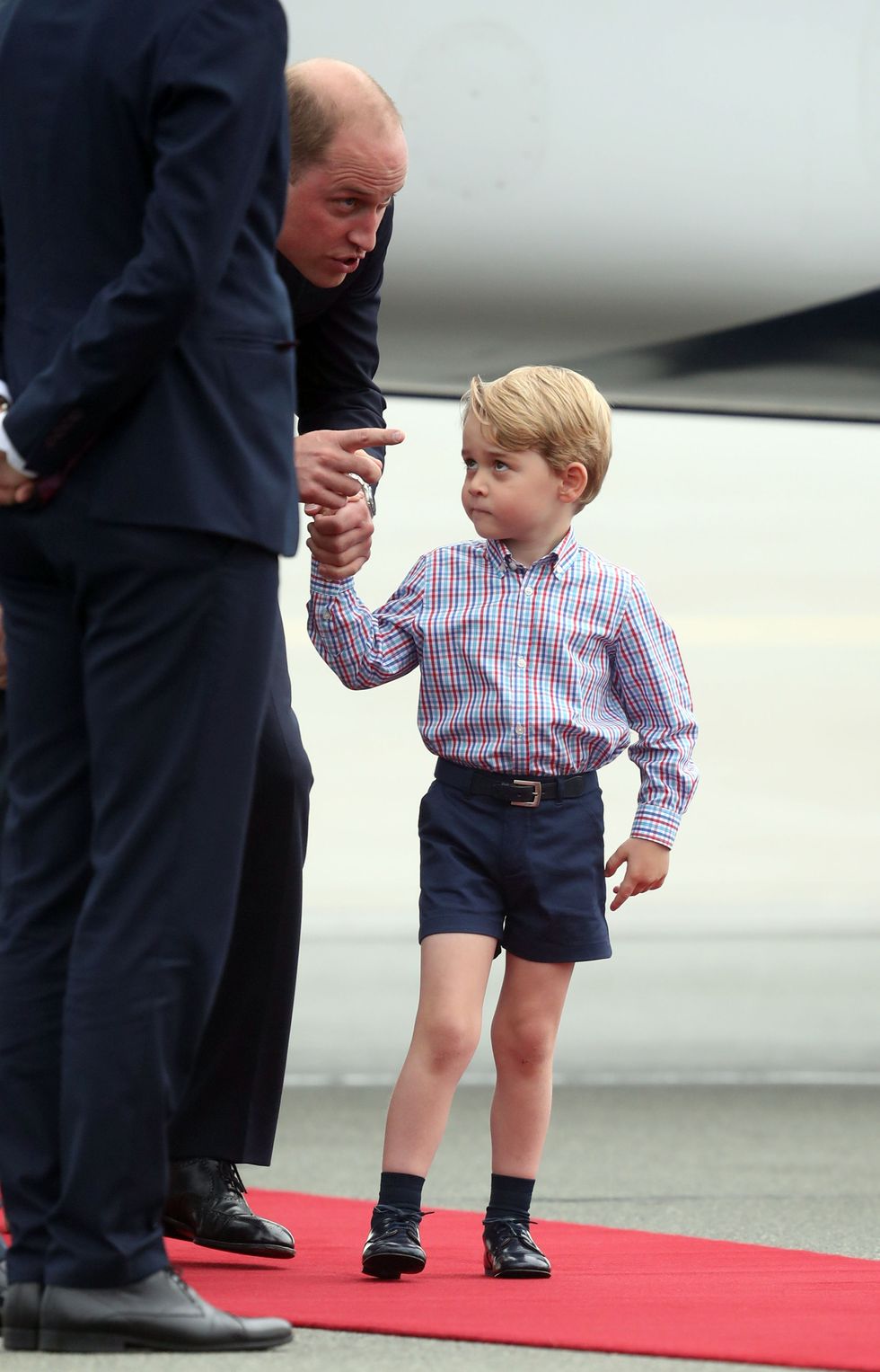 The Duke of Cambridge at Warsaw's Chopin Airport with Prince George at the start of their five-day tour of Poland and Germany.