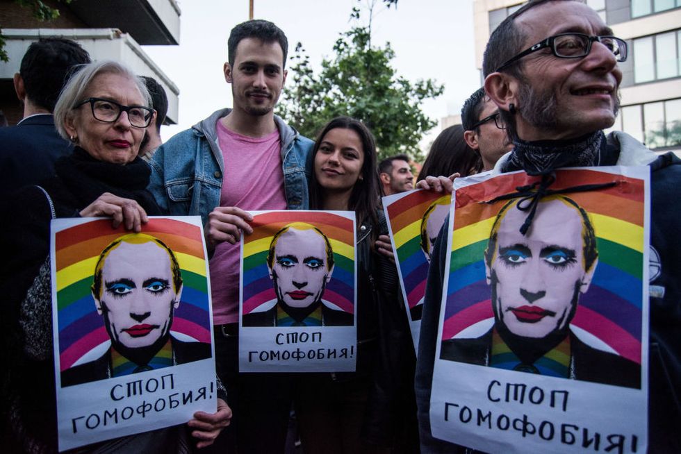 People with placards with face of Vladimir Putin during a protest against homosexual extermination in Chechnya in front of the Russian Embassy | ELLE UK