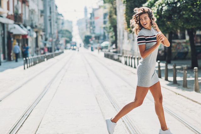 Girl crossing the street and looking back| ELLE UK