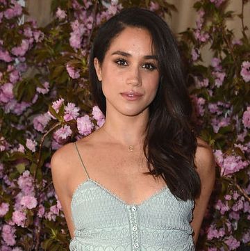 meghan markle standing against a floral backdrop