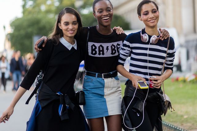 models arm in arm together street style