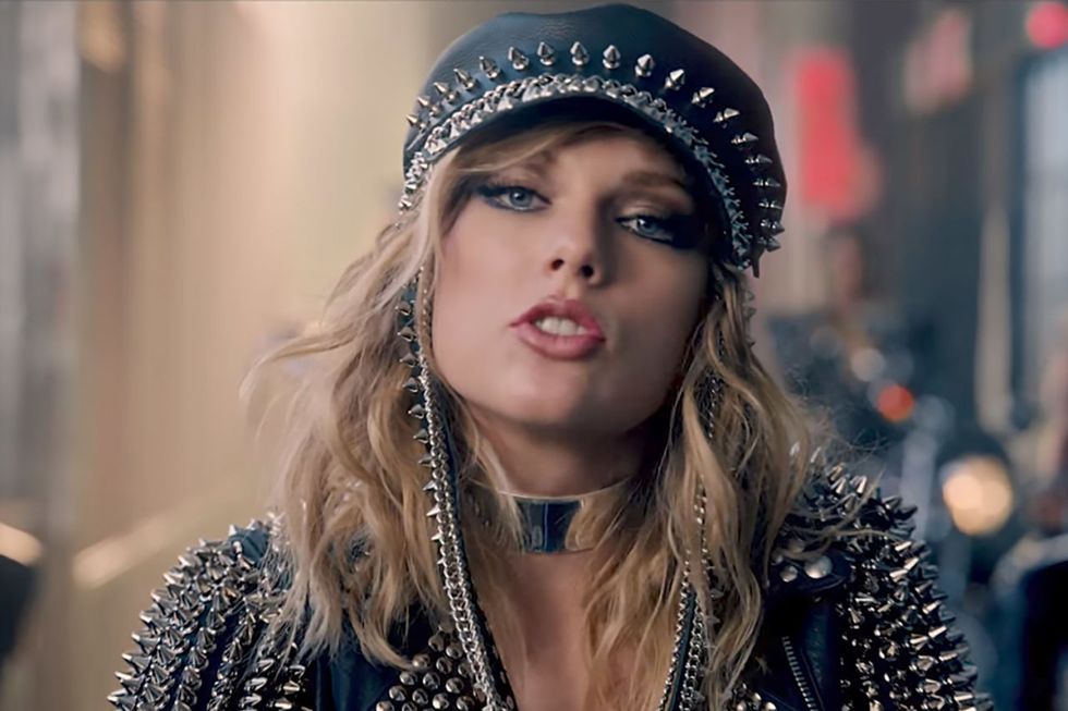 <p>Coming to a biker gang near you, studded-leather Taylor can be seen with gunmetal-gray under-eye shadow, sheer-peach lips, and textured waves.</p>