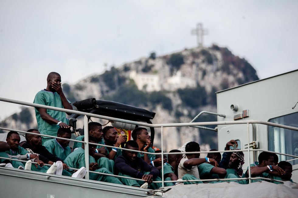 Migrants disembark from the Spanish ship 'Cantabria' in the harbour of Salerno, Italy