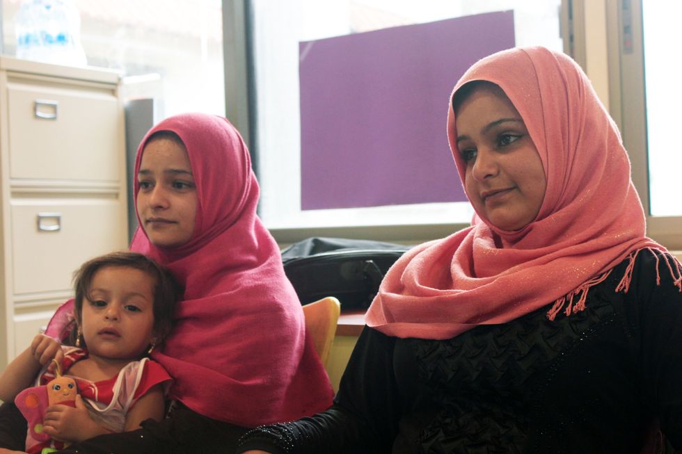 On the right is 17-year-old Fatima Khaled el Omar, and 4-year-old daughter Nada. On the right is 14-year-old Nour Abdel Hakim el Omar | ELLE UK