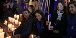 Lebanese activists take part in a candle vigil to raise awareness over violence against women, outside Beirut's National Museum on December 23, 2017. Dozens of people demonstrated in Beirut and lit candles to mourn the lives of four women, including a British citizen, who were all killed in Lebanon in various incidents in just one week | ELLE UK