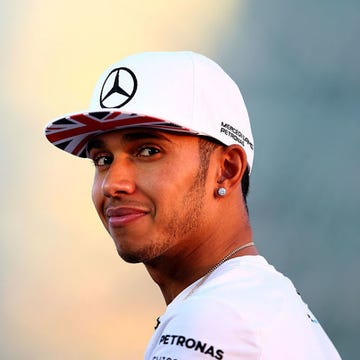 Lewis Hamilton of Great Britain and Mercedes GP looks on as he speaks with members of the media during previews ahead of the Abu Dhabi Formula One Grand Prix at Yas Marina Circuit on November 20, 2014 in Abu Dhabi, United Arab Emirates | ELLE UK