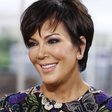 kris jenner smiling to camera in a floral purple top