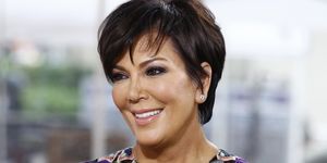 kris jenner smiling to camera in a floral purple top