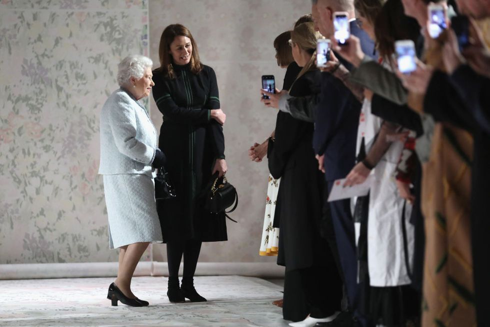 Queen Elizabeth II and Chief Executive of the British Fashion Council Caroline Rush attend the Richard Quinn show during London Fashion Week February 2018 on February 20, 2018 in London, England | ELLE UK