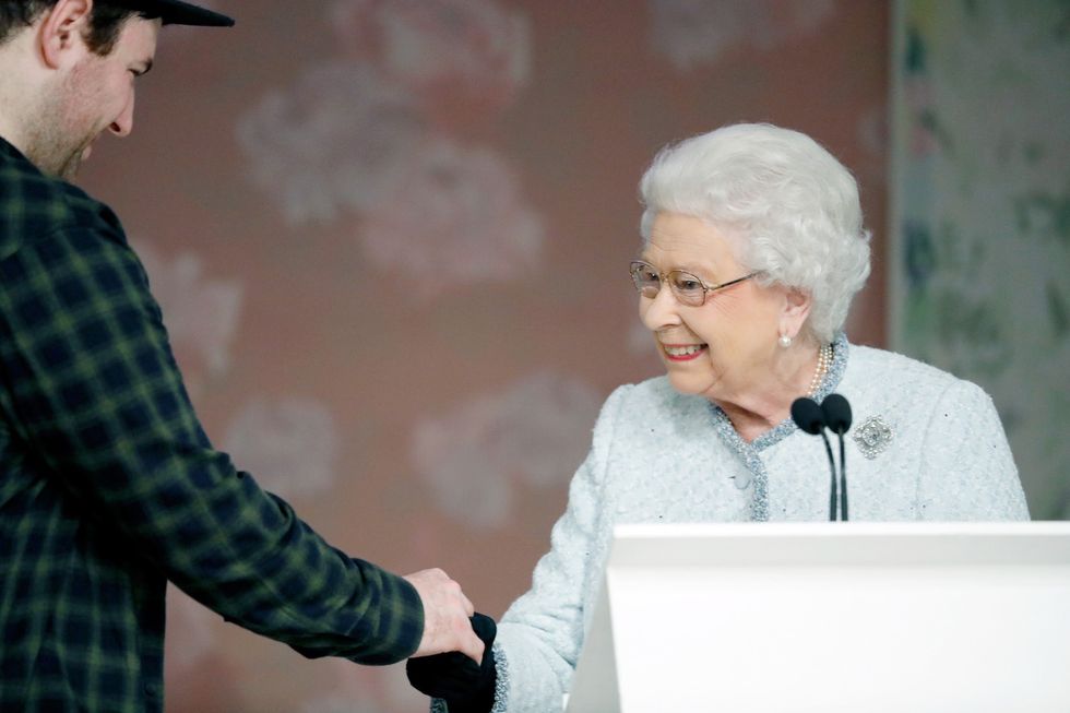 Queen Elizabeth II presenting Richard Quinn with award for British Design london fashion week