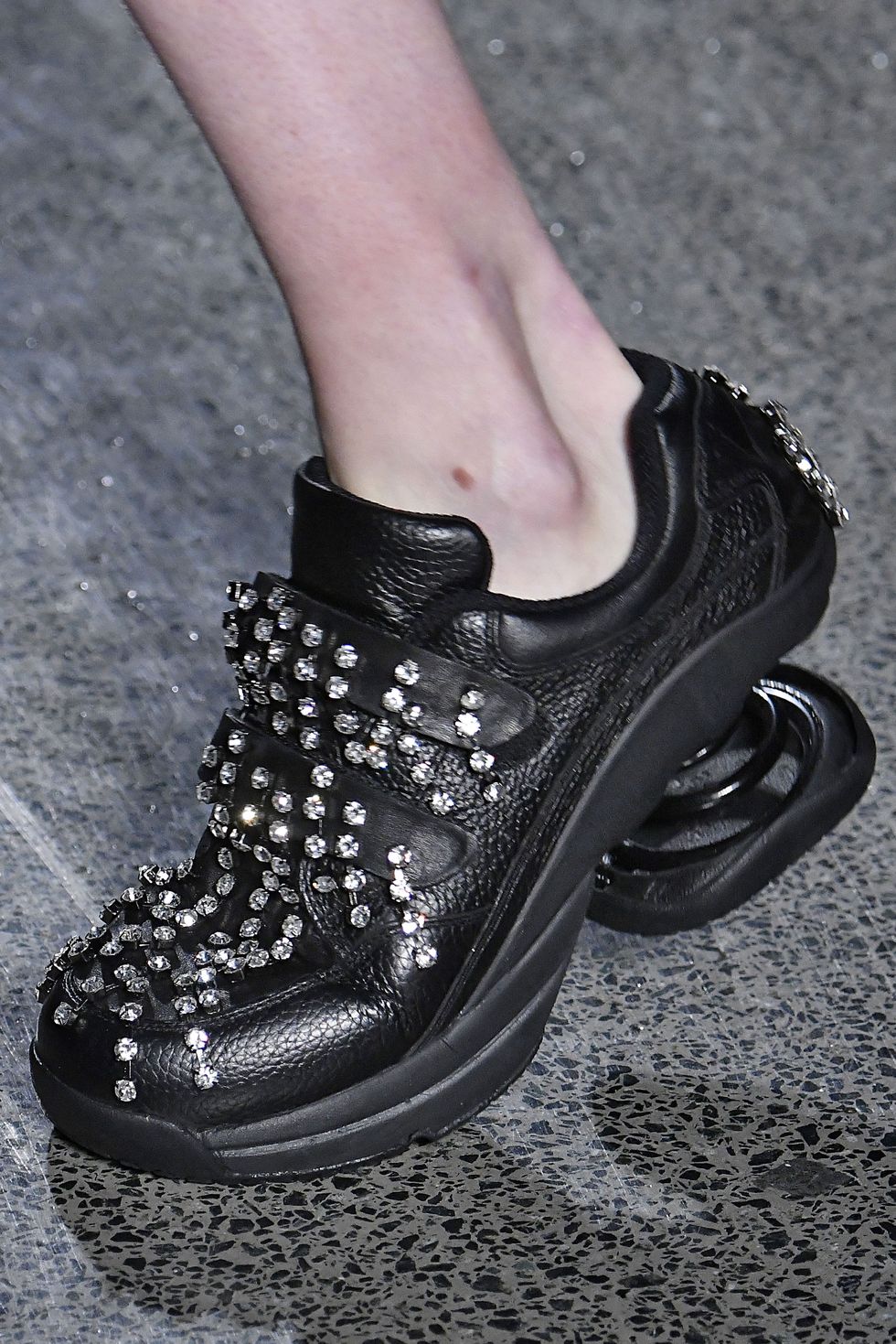Footwear, Human leg, Joint, Style, Fashion, Black, Grey, Close-up, Material property, Fashion design, 