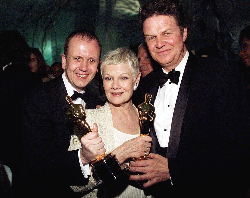 Producer David Parfitt (L), British actress Judi Dench (C) and director John Madden (R) celebrate their Oscar wins for 'Shakespeare in Love' at the Governor's Ball following the 71st Annual Academy Awards in Los Angeles, CA 21 March 1999.