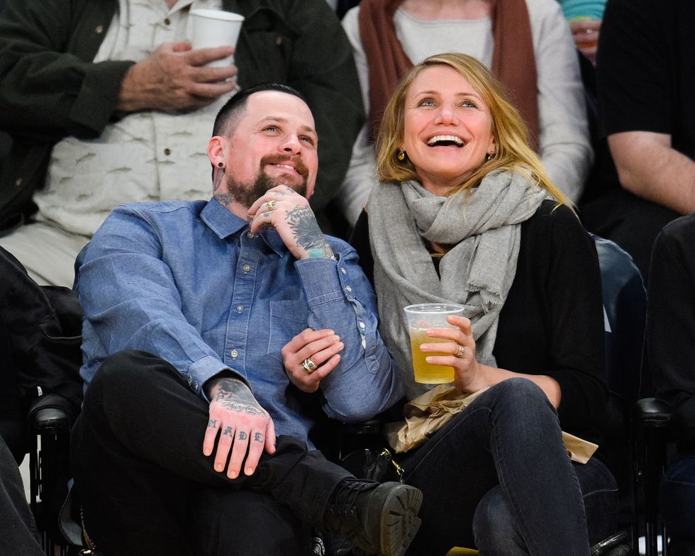 Caption:LOS ANGELES, CA - JANUARY 27: Benji Madden (L) and Cameron Diaz kiss at a basketball game between the Washington Wizards and the Los Angeles Lakers at Staples Center on January 27, 2015 in Los Angeles, California. (Photo by Noel Vasquez/GC Images)