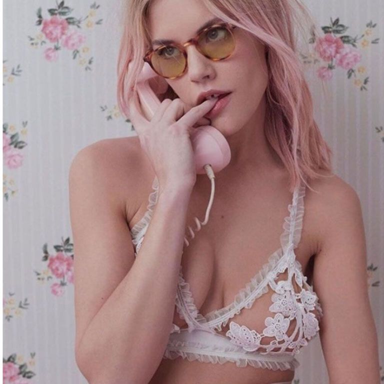 White Lacery Lingerie Near Lipstick and Necklace on Pink