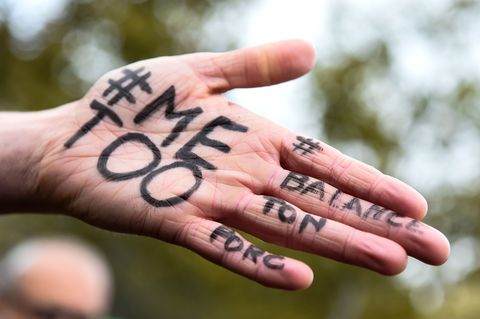 A picture shows the messages '#Me too' and #Balancetonporc ('expose your pig') on the hand of a protester during a gathering against gender-based and sexual violence called by the Effronte-e-s Collective, on the Place de la Republique square in Paris on October 29, 2017. #MeToo hashtag is the campaign encouraging women to denounce experiences of sexual abuse that has swept across social media in the wake of the wave of allegations targeting Hollywood producer Harvey Weinstein | ELLE UK