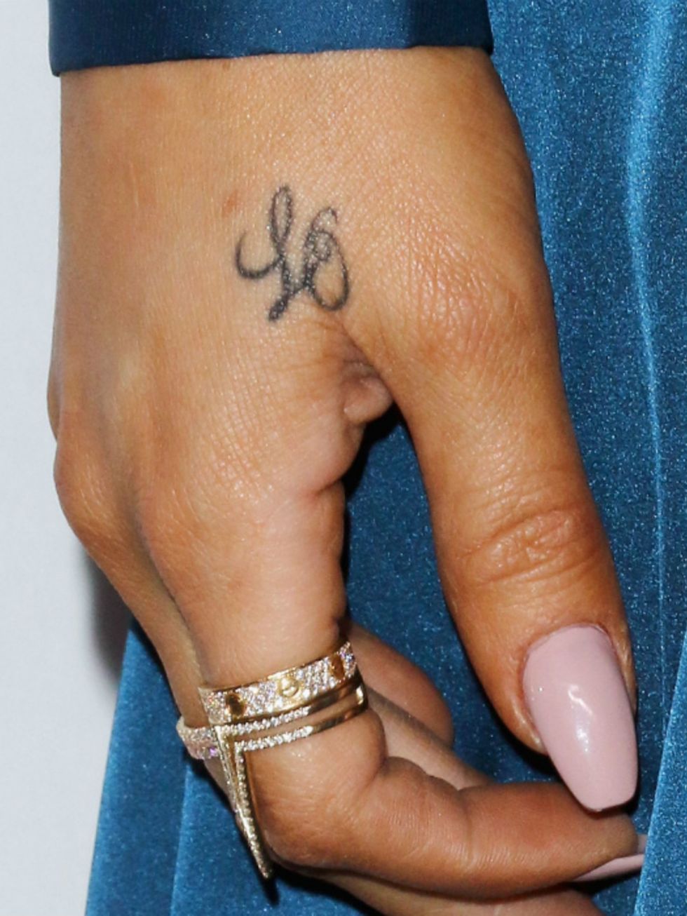 Finger, Skin, Tattoo, Wrist, Joint, Nail, Pattern, Organ, Fashion accessory, Symbol, 