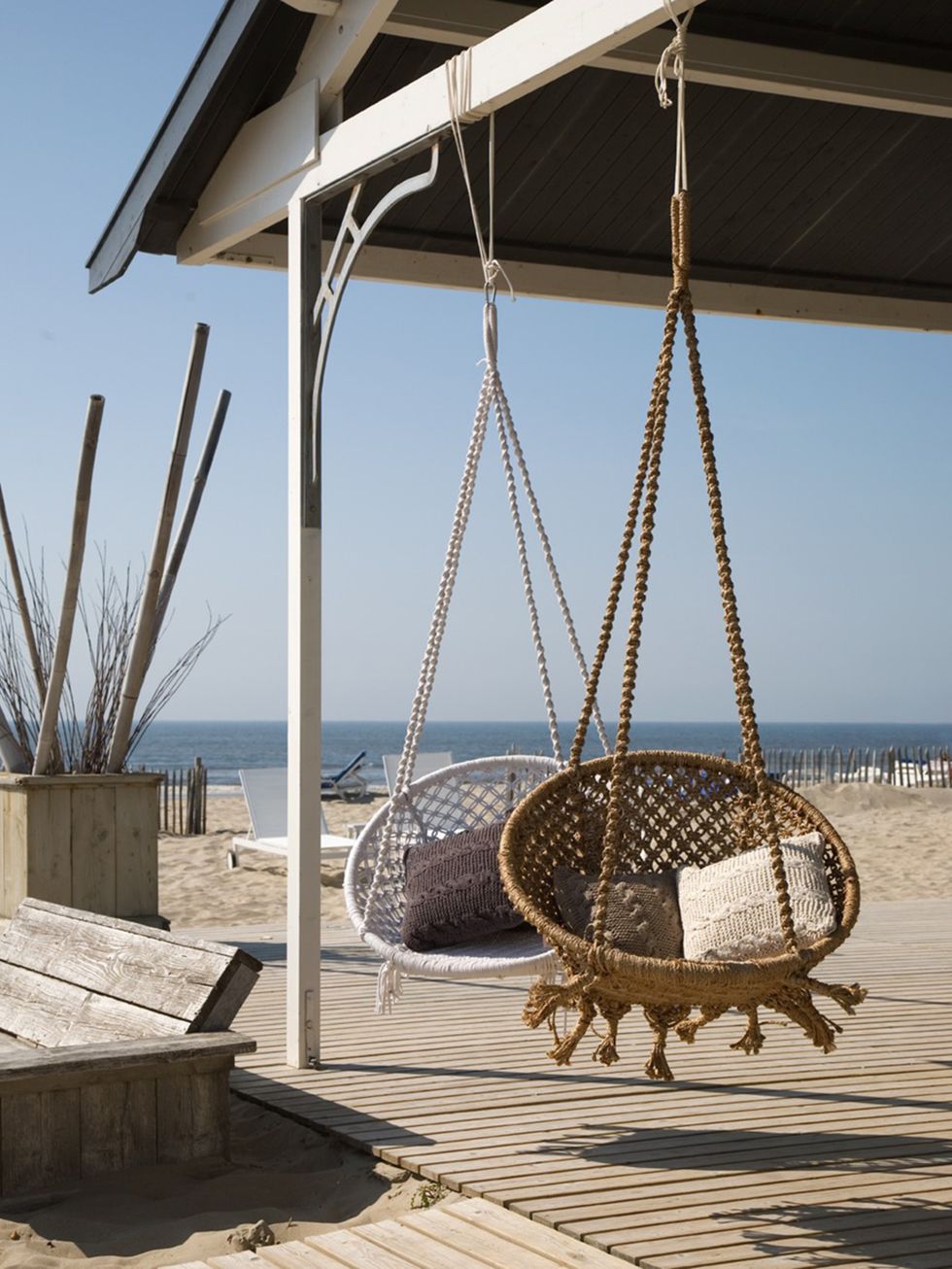 Swing, Shade, Iron, Metal, Cobblestone, Beach, Building material, Basket, Outdoor structure, Wicker, 
