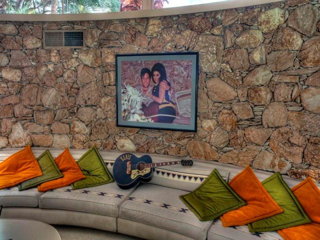 Wall, Couch, Art, Picture frame, Pillow, Painting, Throw pillow, studio couch, Advertising, Stone wall, 