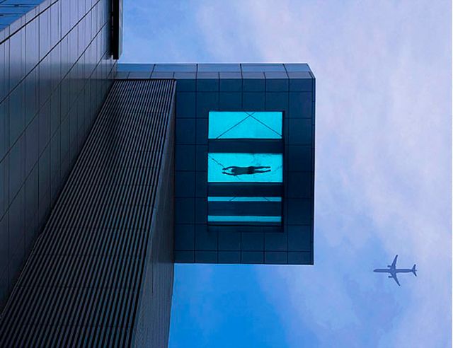 Blue, Architecture, Facade, Commercial building, Glass, Aircraft, Line, Azure, Parallel, Air travel, 