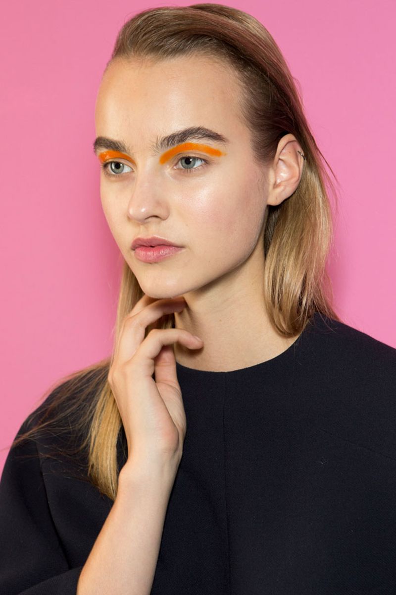 <p>A graphic swipe of orange pigment was traced right under the brows backstage at the Salvatore Ferragamo spring 2017 runway show.</p>