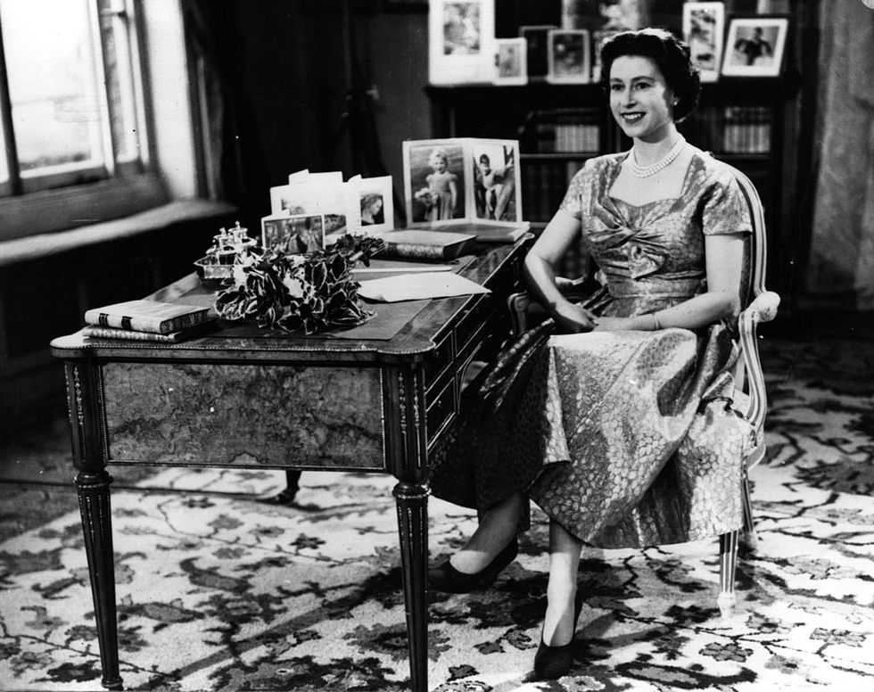 <p>Since 1952, Queen Elizabeth has delivered a Christmas message, which is usually recorded in advance and aired on December 25. (She's only missed one year, in 1969.) This photo is from her first televised message, in 1957. Though you can't see him, Elizabeth is smiling at an off-camera Prince Philip. </p>