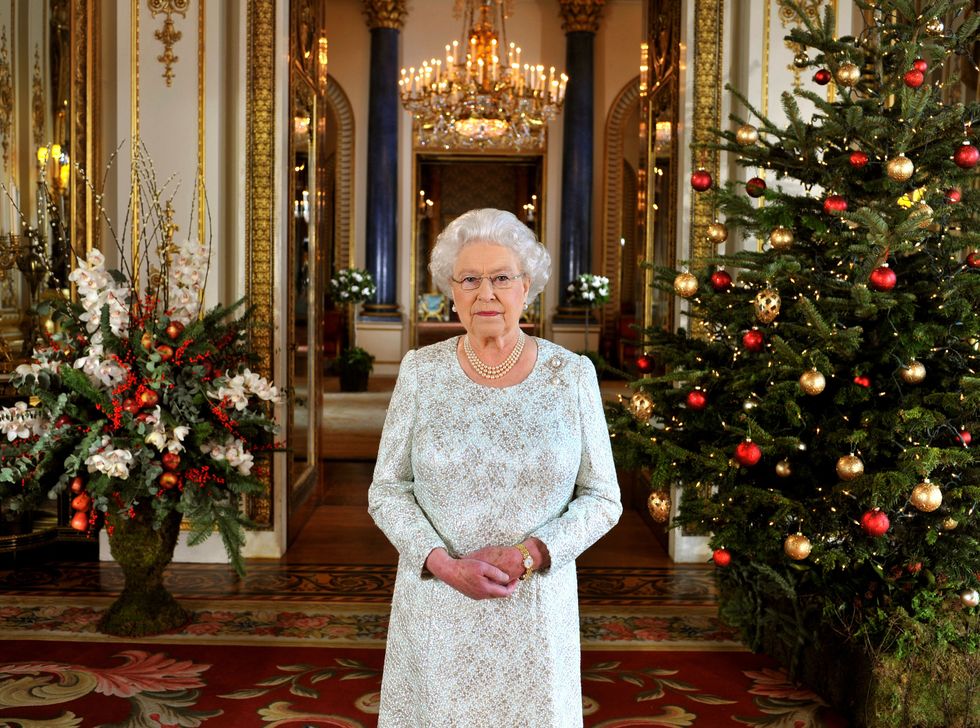 <p>In this photo from her 2012 Christmas address, we can get a great look at the holiday decorations at Buckingham Palace, from the fabulous floral arrangements to the red-and-gold decorated tree. </p>