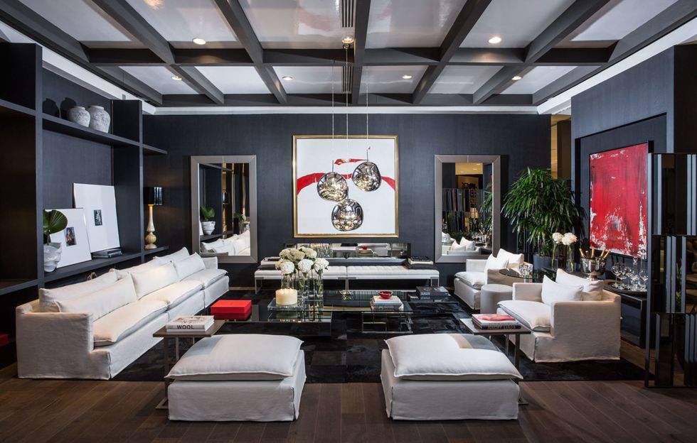 <p>Touches of red and lace accents line Mirtha's living space of black, white and cool grays. With contemporary art additions and sleekly shaped furniture, the room epitomizes Valentino's bold vibe. </p>