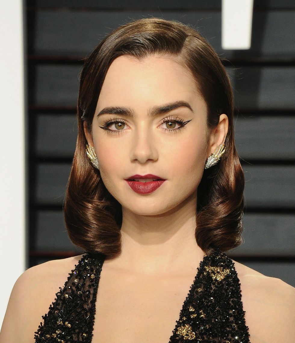 <p>We begin with Miss Lily Collins, who is doing those glassy waves pretty much true to form. (Why are they still such a crowdpleaser? Easy—because Old Hollywood glamour never dies, and it goes so well with so many kinds of dresses, it is basically the Nudist sandal of hair.) So yes, this means that you could still do exactly the same hair now, and it would be modern by virtue of you being a 21st-century woman. However...</p>