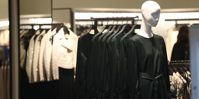 Boutique, Fashion, Fashion design, Outerwear, Room, Suit, Mannequin, Clothes hanger, Black-and-white, Formal wear, 