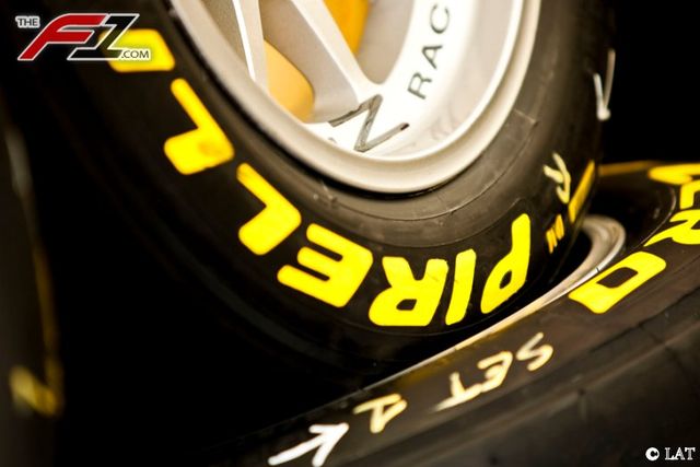 Automotive tire, Yellow, Rim, Text, Synthetic rubber, Automotive wheel system, Logo, Font, Orange, Spoke, 