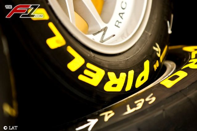 Automotive tire, Yellow, Rim, Synthetic rubber, Automotive wheel system, Logo, Tread, Spoke, Orange, Alloy wheel, 