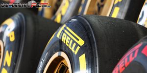 Automotive tire, Yellow, Formula one tyres, Synthetic rubber, Automotive wheel system, Rim, Logo, Tread, Auto part, Formula one car, 