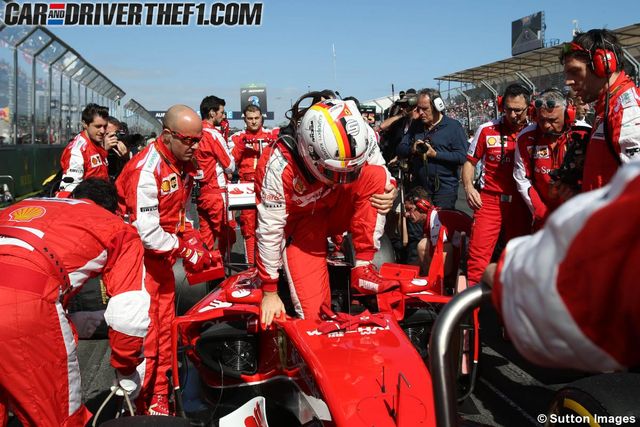 Red, Team, Race track, Helmet, Motorsport, Racing, Crew, Sports gear, Race car, Open-wheel car, 