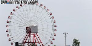 Ferris wheel, Daytime, Road, Infrastructure, Road surface, Asphalt, Photograph, Automotive tire, Red, Public space, 