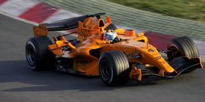 Tire, Wheel, Automotive tire, Automotive design, Open-wheel car, Automotive wheel system, Motorsport, Formula one tyres, Orange, Asphalt, 