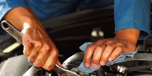 Auto mechanic, Mechanic, Automobile repair shop, Auto part, Metalworking hand tool, Hand, Engine, Hood, Trade, 