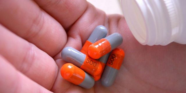 Pill, Finger, Skin, Capsule, Medicine, Prescription drug, Red, Colorfulness, Orange, Pharmaceutical drug, 