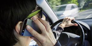 Driving, Vehicle door, Hand, Eyewear, Auto part, Glasses, Steering wheel, Windshield, Technology, Vehicle, 