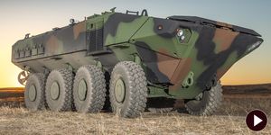 Motor vehicle, Wheel, Mode of transport, Combat vehicle, Military vehicle, Green, Self-propelled artillery, Armored car, Auto part, Machine, 