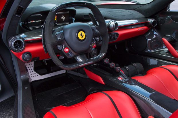 Land vehicle, Vehicle, Car, Steering wheel, Red, Steering part, Supercar, Center console, Luxury vehicle, Sports car, 
