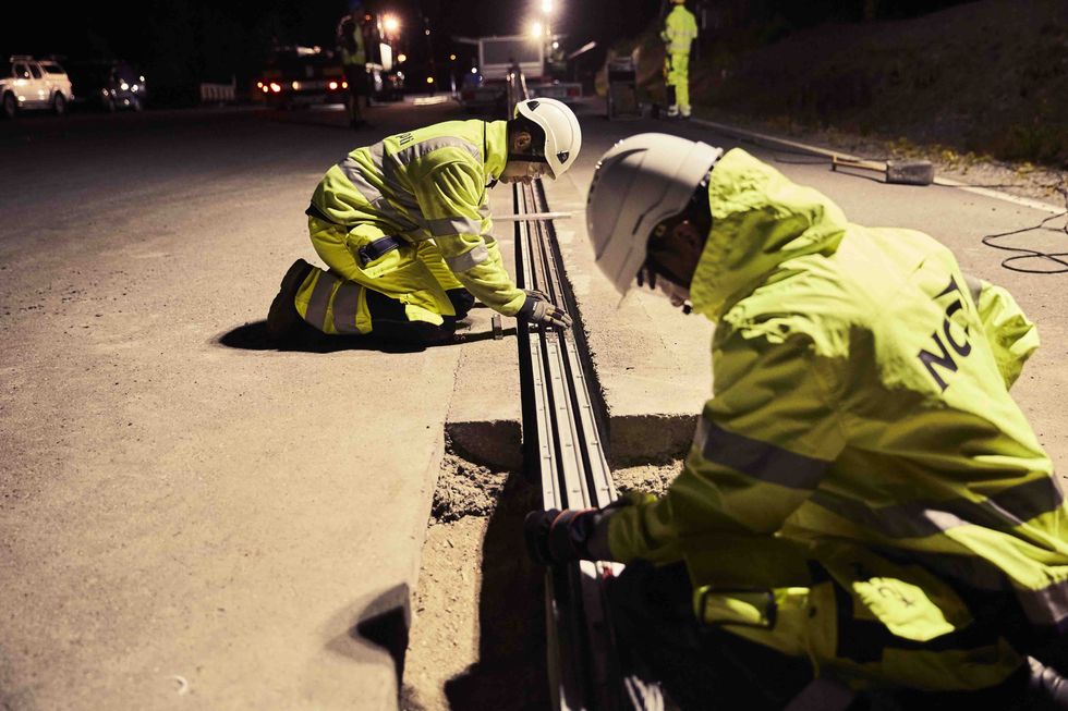 Yellow, Asphalt, Road surface, Street, Road, Emergency service, Night, Personal protective equipment, High-visibility clothing, Emergency, 