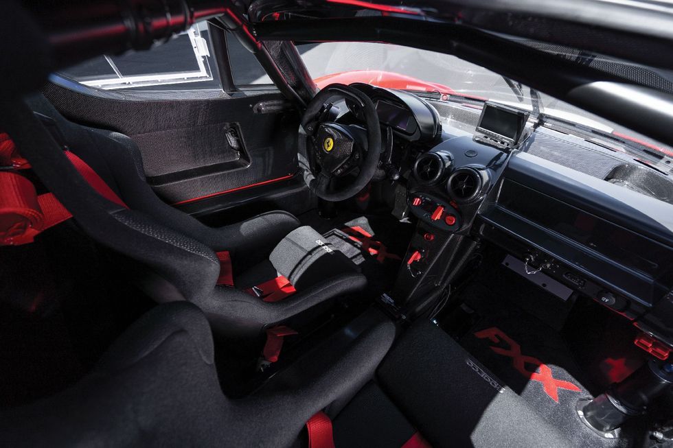 Land vehicle, Vehicle, Car, Steering wheel, Automotive design, Red, Luxury vehicle, Steering part, Center console, Supercar, 